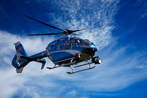 API Capacitors blue helicopter in the blue sky.