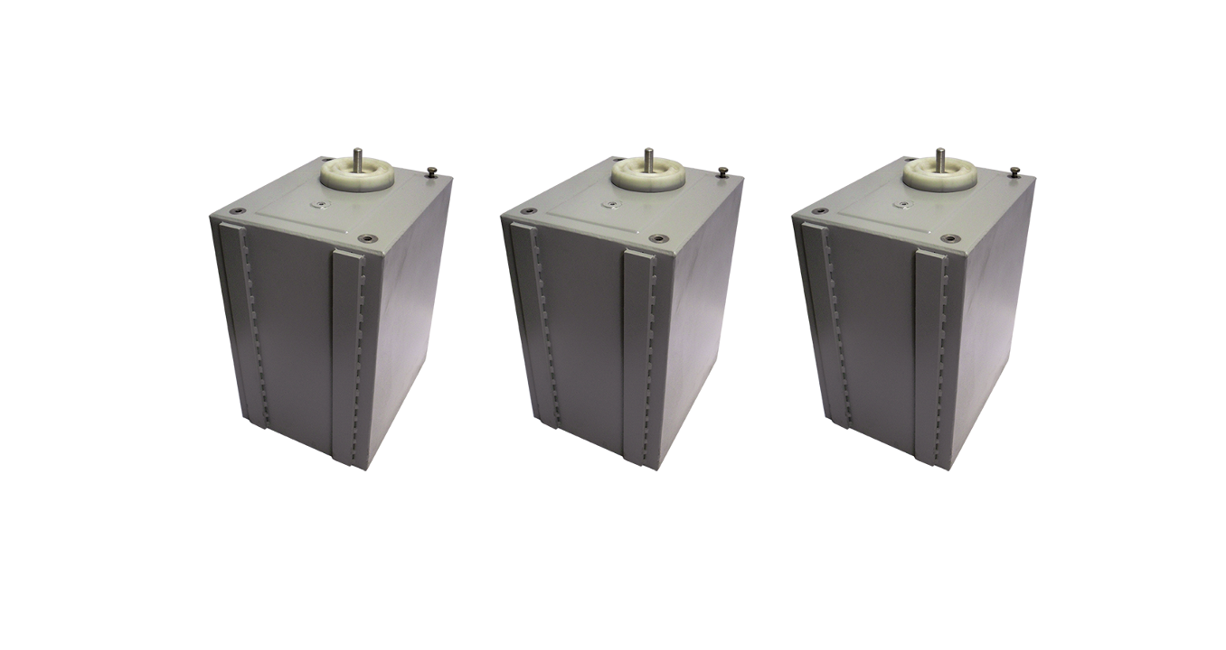 Three grey energy storage capacitors lined up on a white background