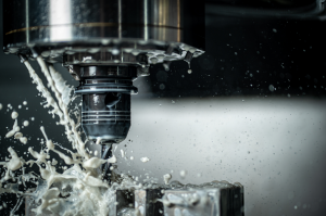 Modern close up shot of a CNC machine in action, liquid flying out of the tooling