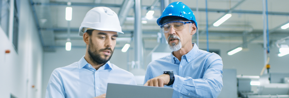 Head Engineer of the Project Holds Laptop and Discusses Product Details with Chief Engineer while They Walk Through Modern Factory. Partnership opportunities available at GD Rectifiers. Why shop with us - GD Rectifiers.