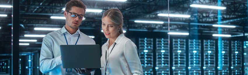 Female Chief Engineer Talks with Electronics Specialist, Explaining Things, While Works on Laptop Computer and Agrees with Her. Modern and Evening Office with Stylish Colleagues