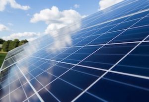 solar panels and wind turbines on a sunny day.